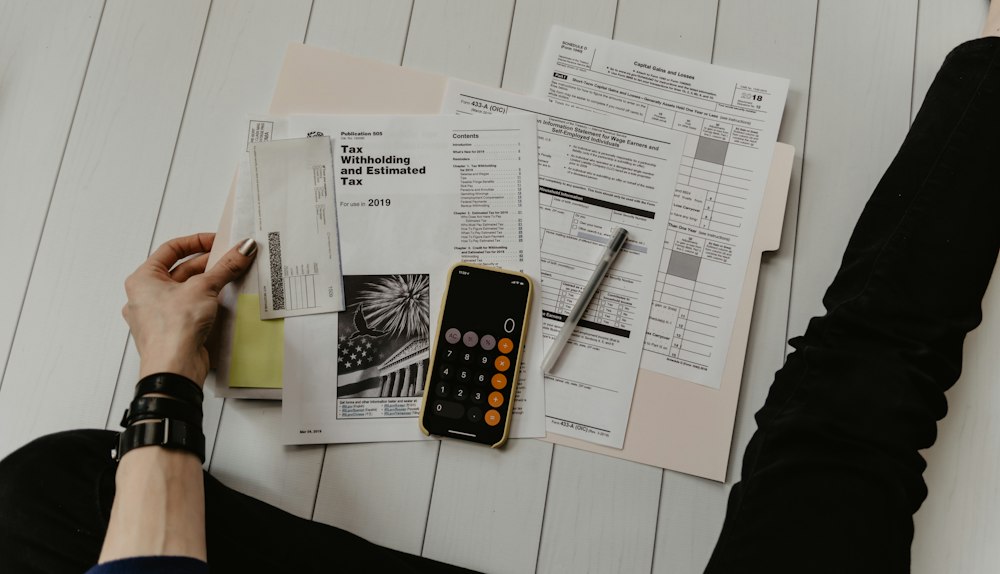 Stacks of paper trade documents and a clipboard — the manual process export documentation software replaces